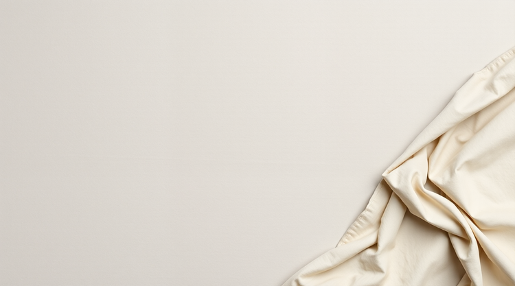 Pale greige brushed cotton twill laid flat, with folds at the right edge
